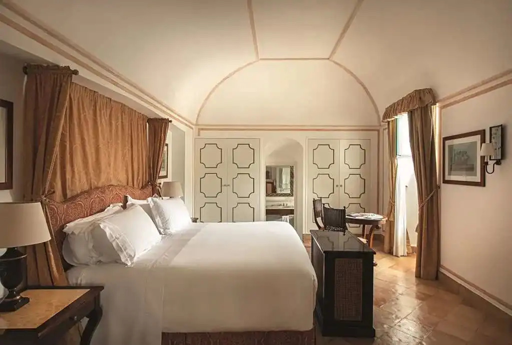 Elegant hotel room with vaulted ceilings, contemporary furnishings, and romantic Italian design