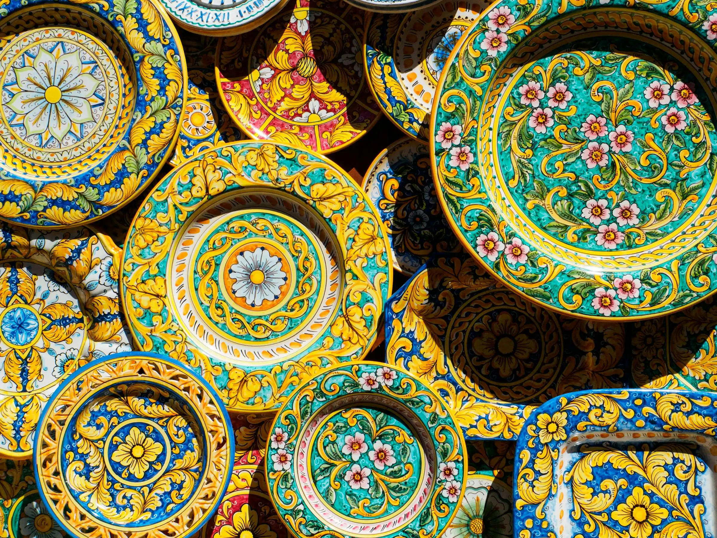 Colorful hand-painted ceramic plates and dishes displaying traditional Italian craftsmanship