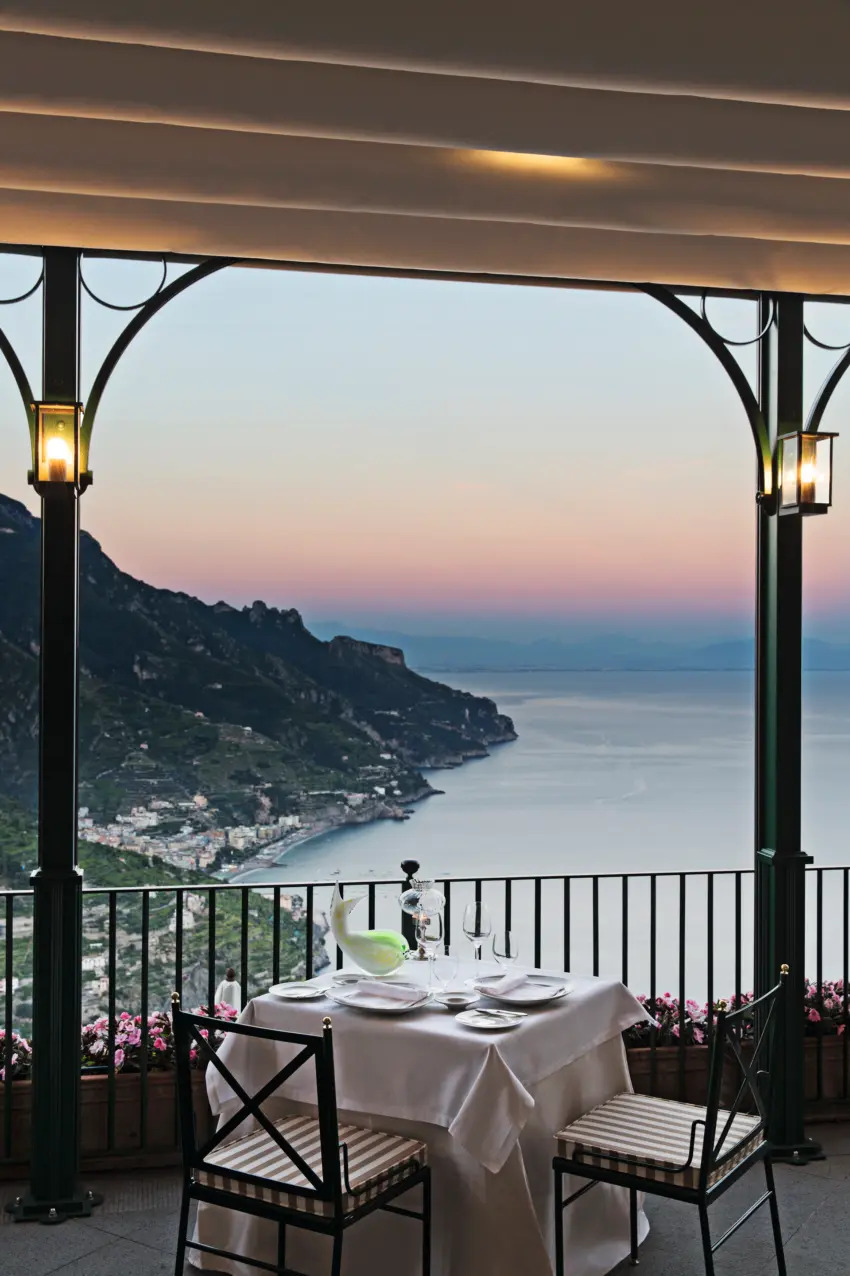 Picturesque hillside village overlooking the Mediterranean during daytime, traditional Italian coastal architecture